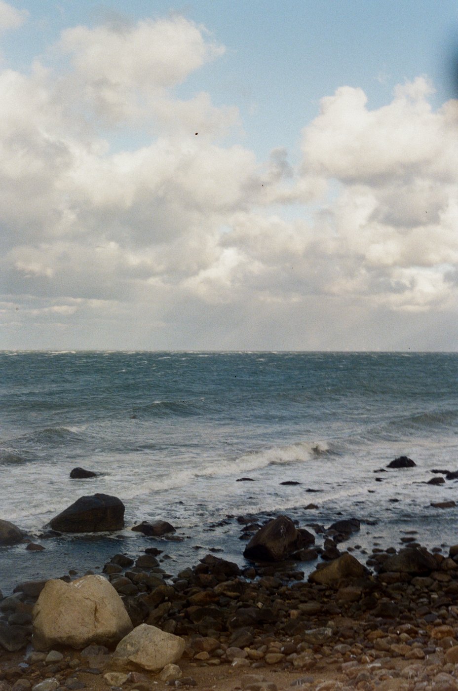 Waves breaking over rocks along the shore