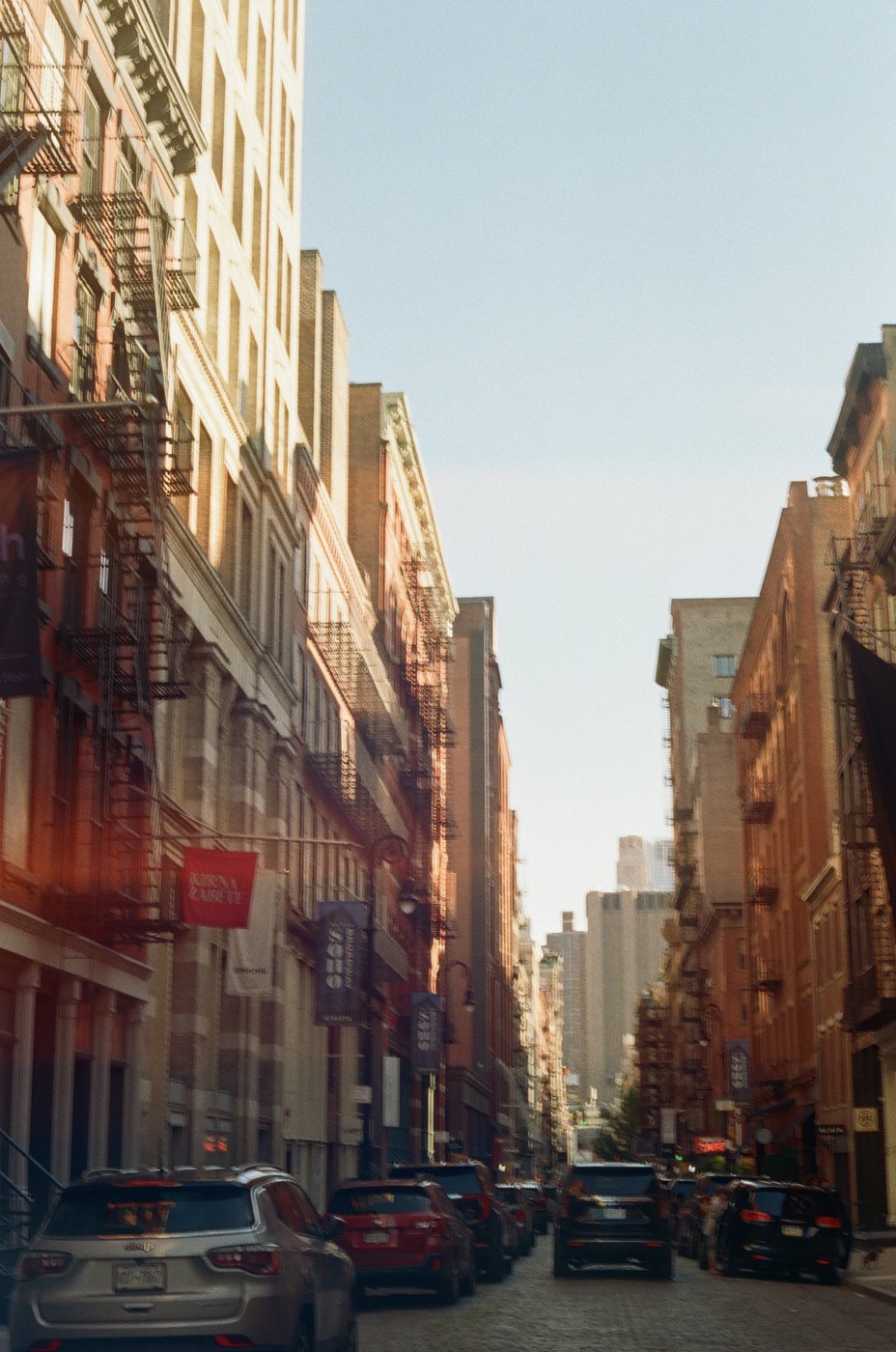 A narrow street lined with fire escapes