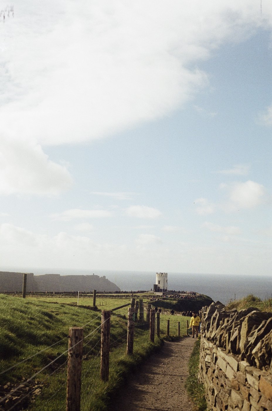 A path along a stone wall overlooking the Irish coast
