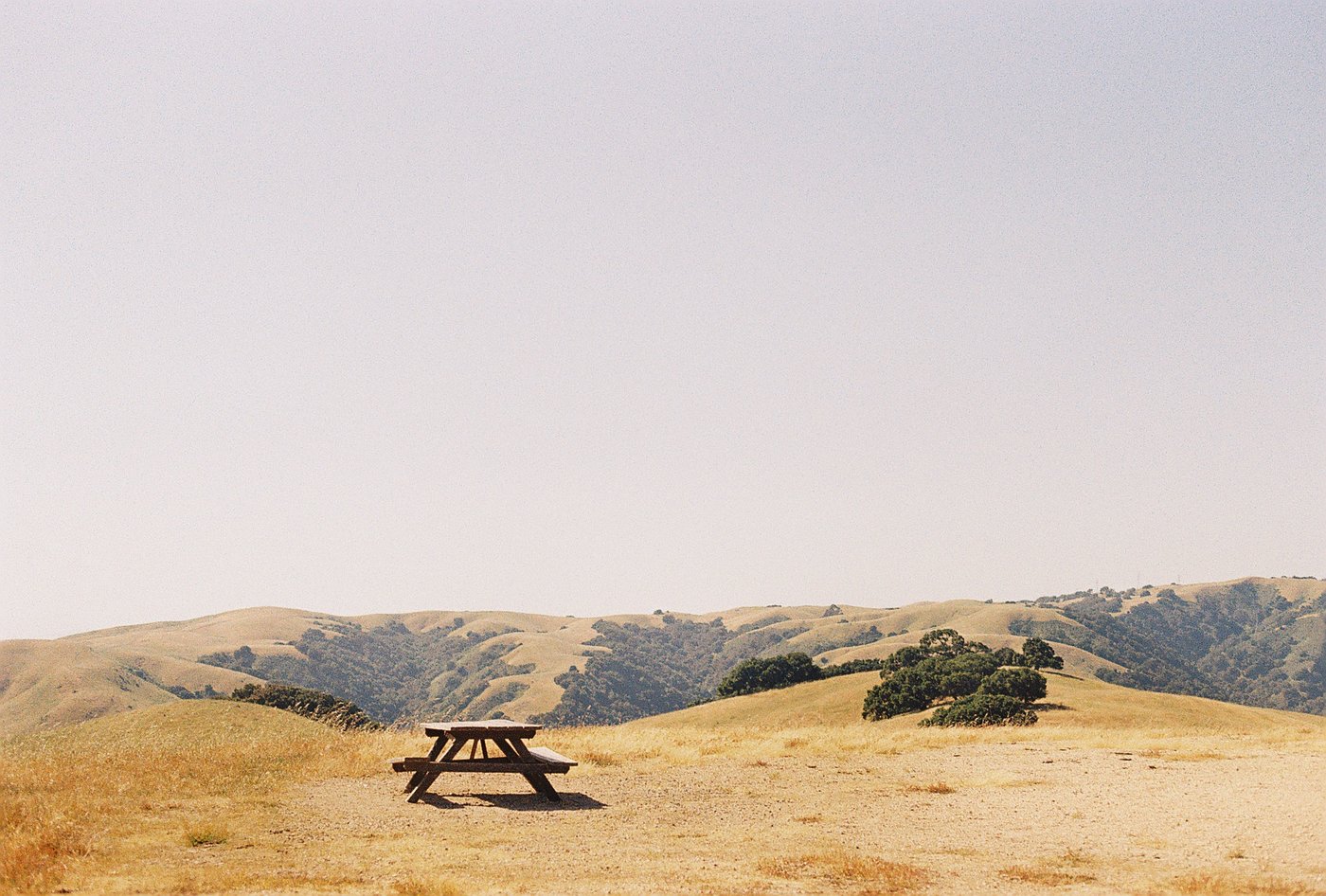 A picnic table on a grassy hillside