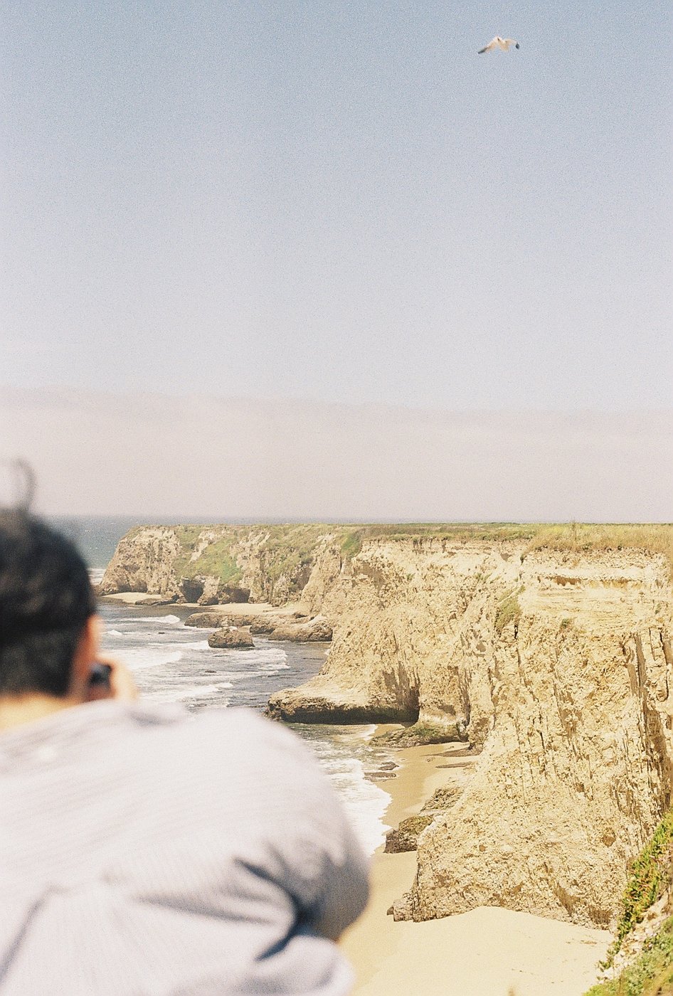 Looking out over a hazy coastal cliff