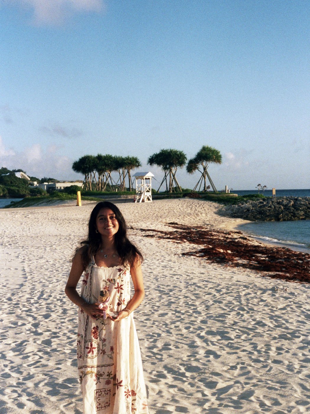 Standing on a beach in a sundress
