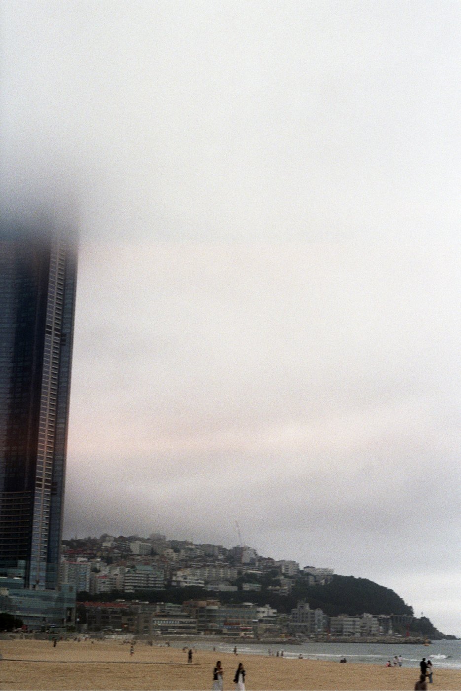 Hazy view of buildings and a beach from above