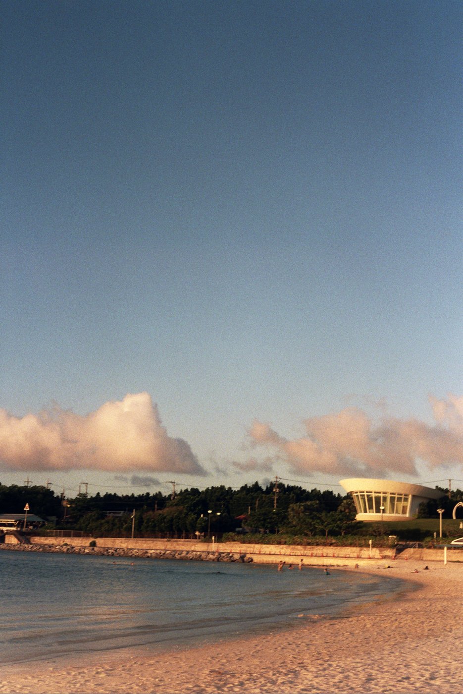 A calm beach with clouds overhead