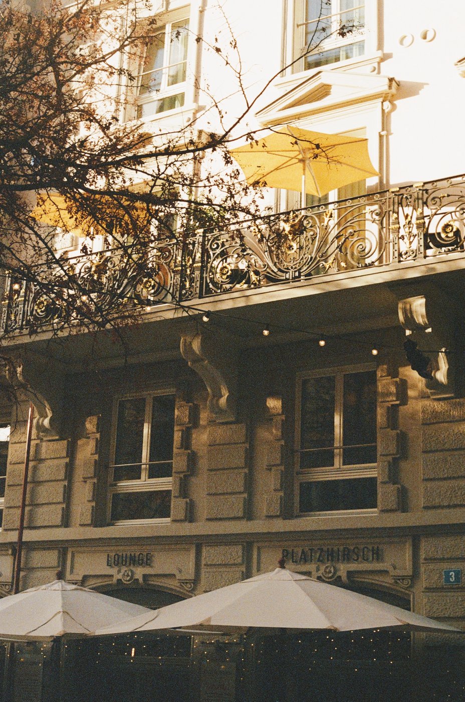 Storefront of Café Zähringer with flags hanging above