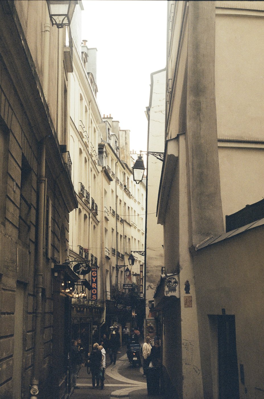 A narrow Parisian street lined with shops