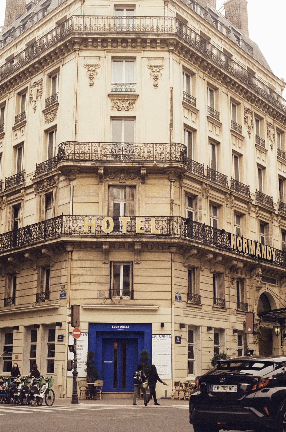 A classic Parisian building facade with a hotel entrance