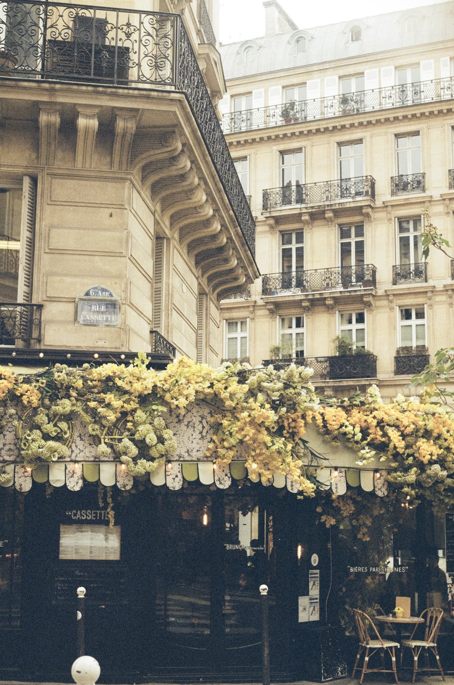 A café covered in autumn leaves on a Parisian corner