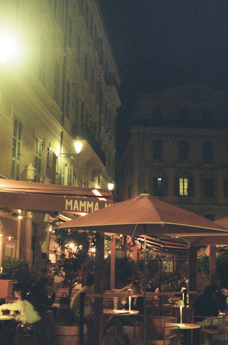 A restaurant terrace on a Nice street at night