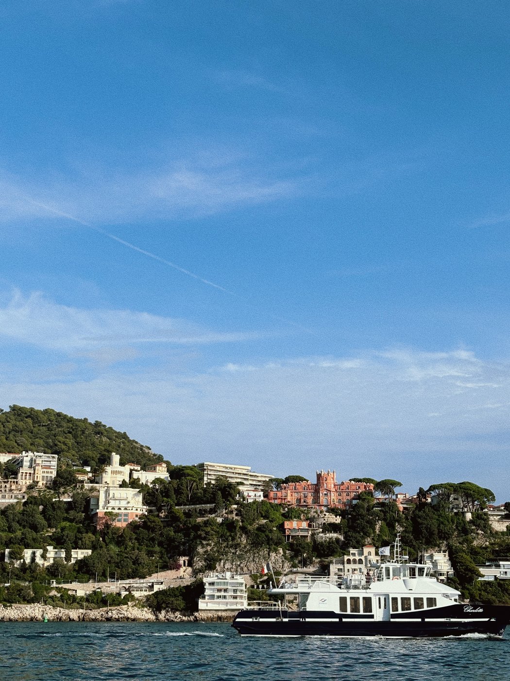 Coastal view of Nice, France with a passing boat