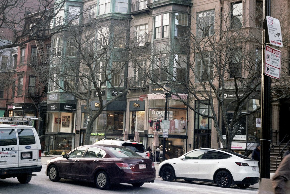 Brownstone-lined street with parked cars