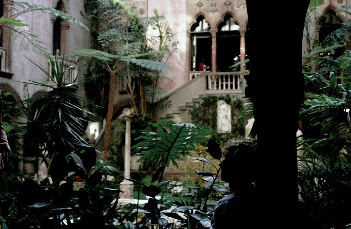 Standing inside a glass-covered courtyard garden